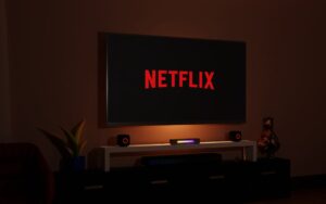 television, Netflix, Netflix logo, room, living room, entertainment, screen, technology, home, decoration, design, interior, space, relaxation, leisure, rest, streaming, streaming services, TV, flat screen, electronics, electronic devices, gadgets, tech gadgets, electronic gadgets, entertainment gadgets, home gadgets, tech gadgets, streaming gadgets, Netflix gadgets.