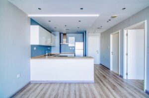 Clean unfurnished apartment interior showcasing spacious layout, raw architectural details, and abundant natural light. Ideal for real estate listings, 3D rendering backgrounds, or minimalist design inspiration.